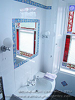 bathroom tile design: white glazed tiles and border tile